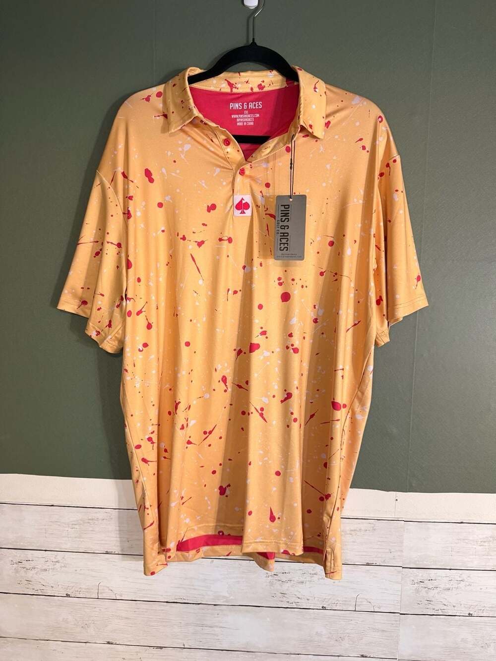 Pins & Aces Men's Golf Polo Shirt - Orange with Pink and White Splatter Print NE